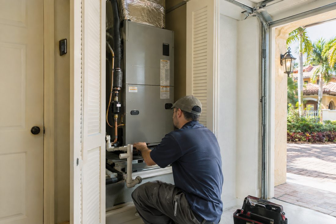 A new heat pump air handler installed in a garage closet at a Spanish-style stucco home in West Palm Beach, FL