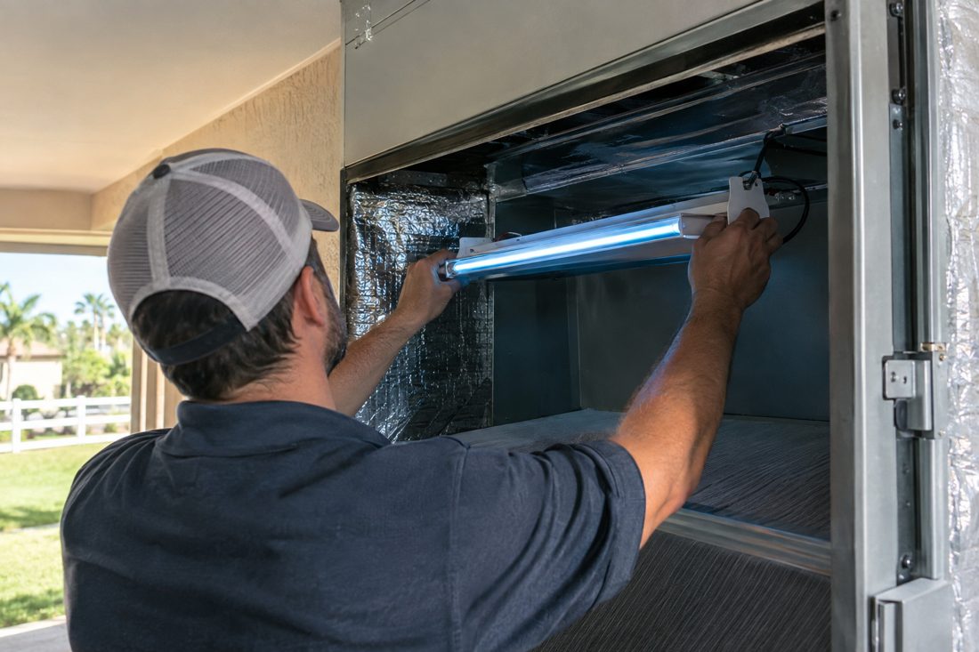 A UV light being installed in a return plenum at a equestrian-area estate home with white fencing in Wellington, Florida in Wellington, FL